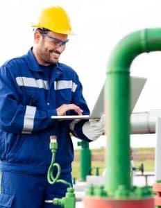 worker checking a pipe